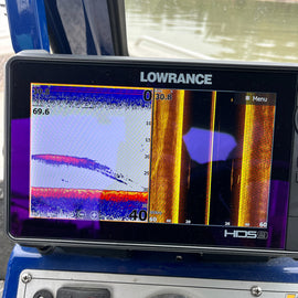 A fish finder screen showing fish marks along the bottom.